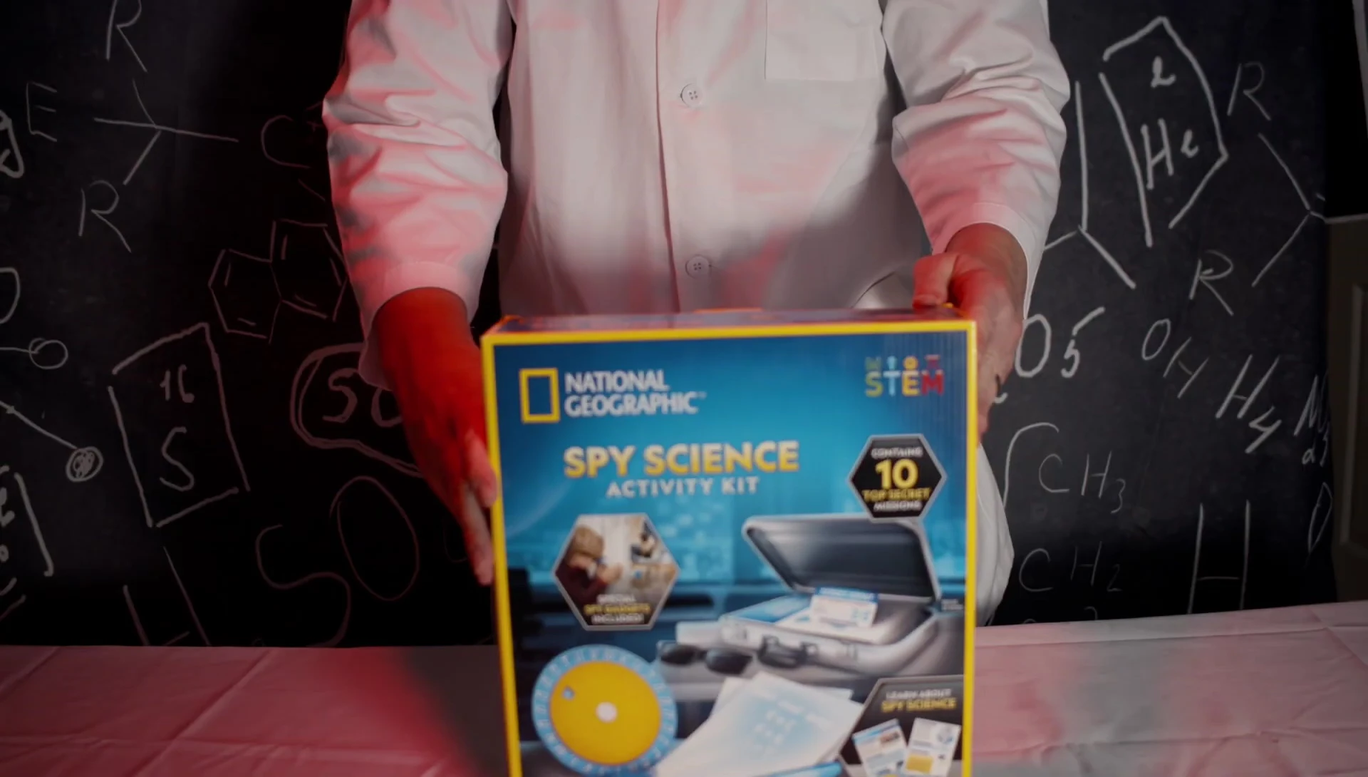 Close-up shot of the Spy Science STEM kit being opened, revealing its contents.