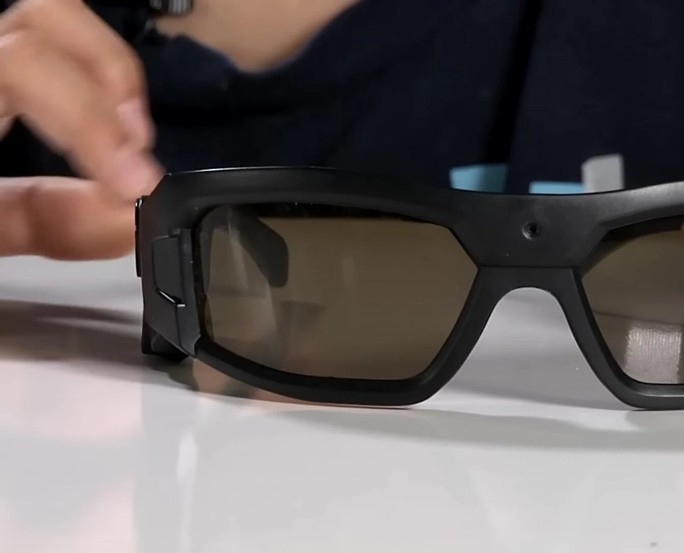 Close-up view of the camera lens and buttons on the glasses.