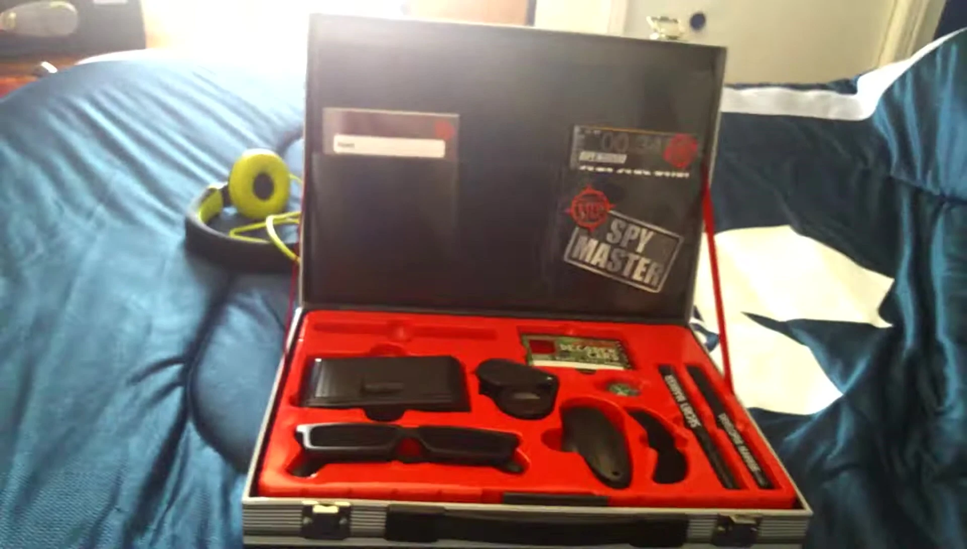 A close-up of the inside of the briefcase, showing the organization of the gadgets.