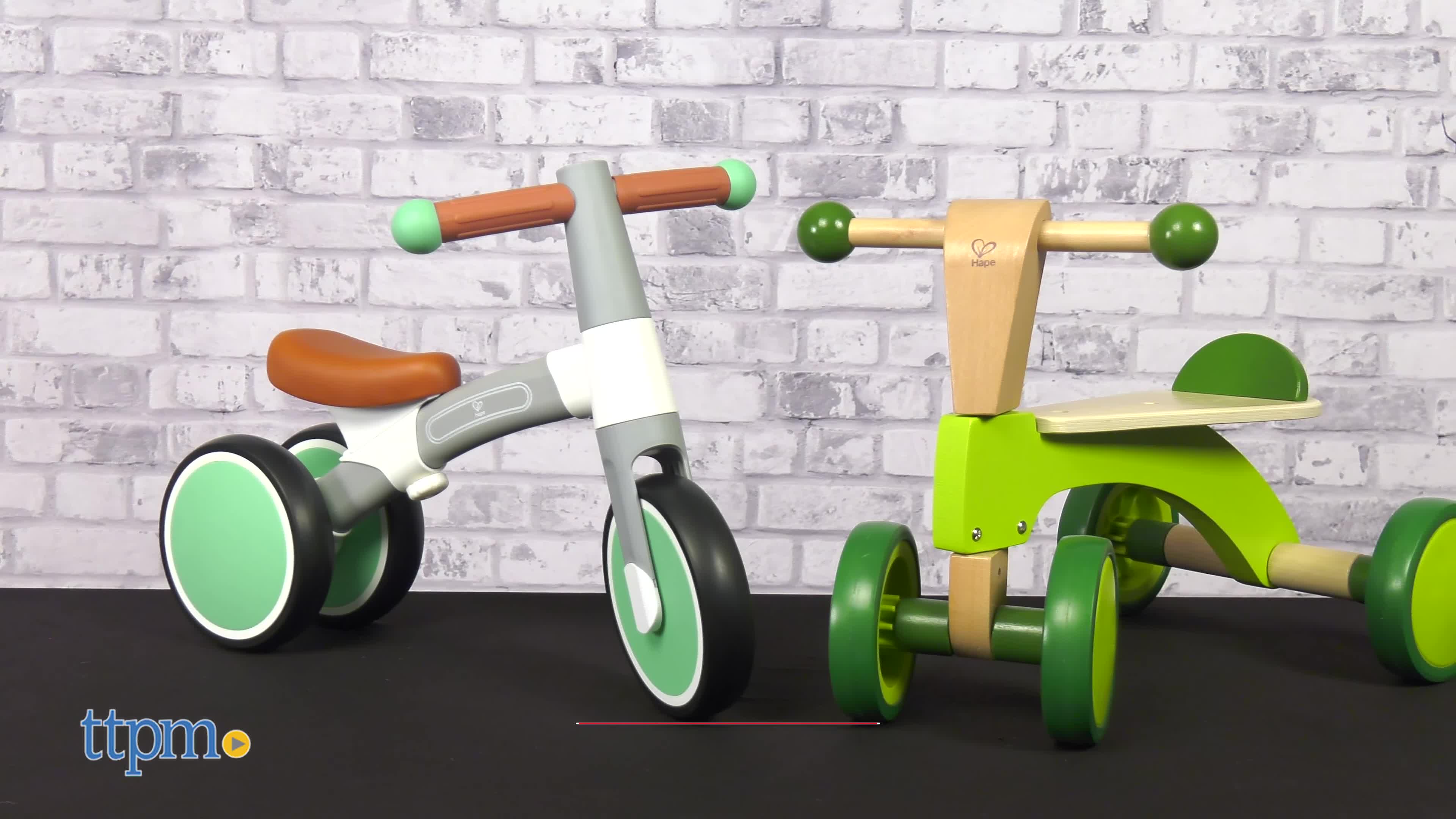 Close-up shot showcasing the wooden body and green color of the Hape Scoot Around.