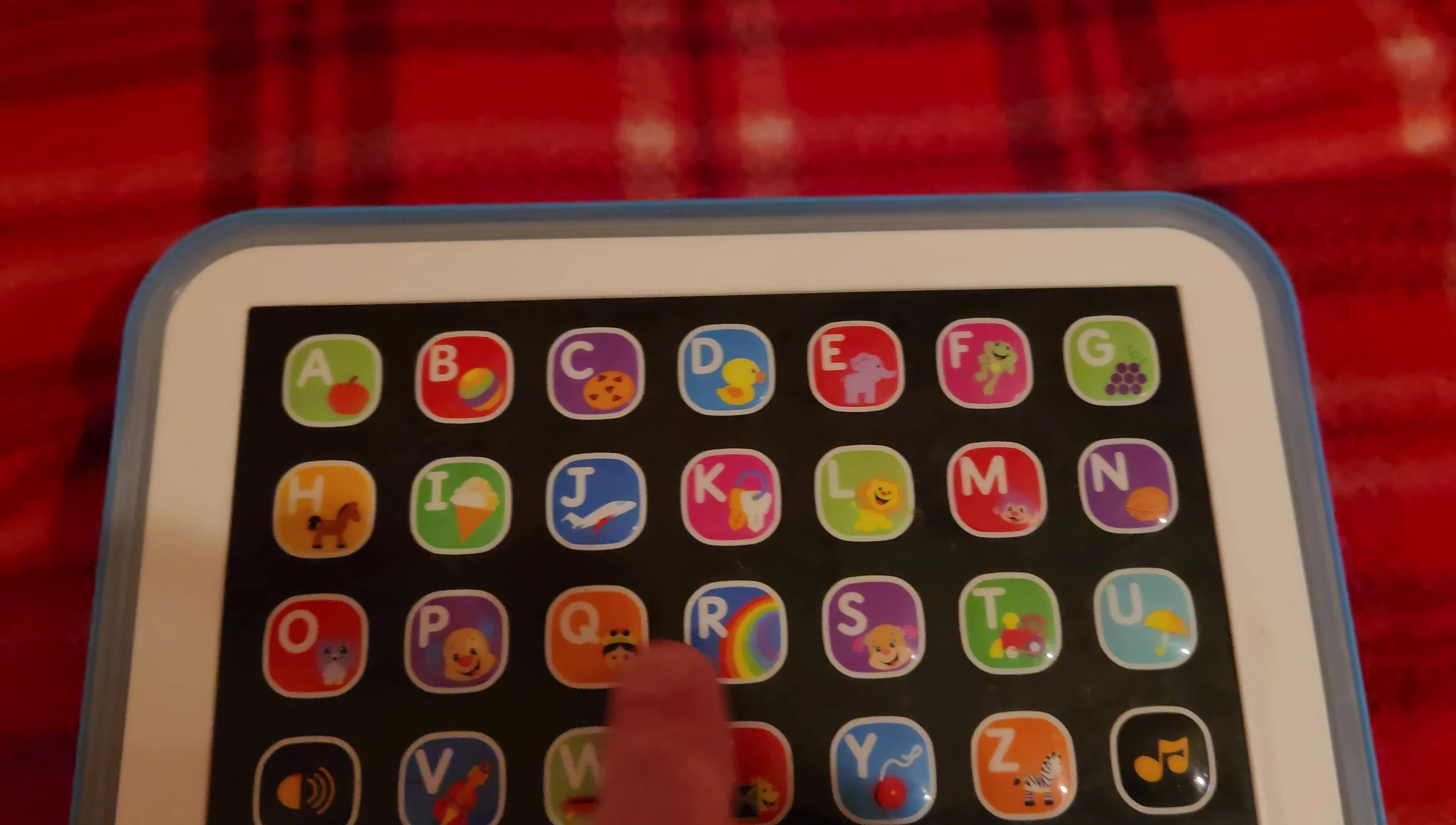 The tablet’s display showing a colored object.