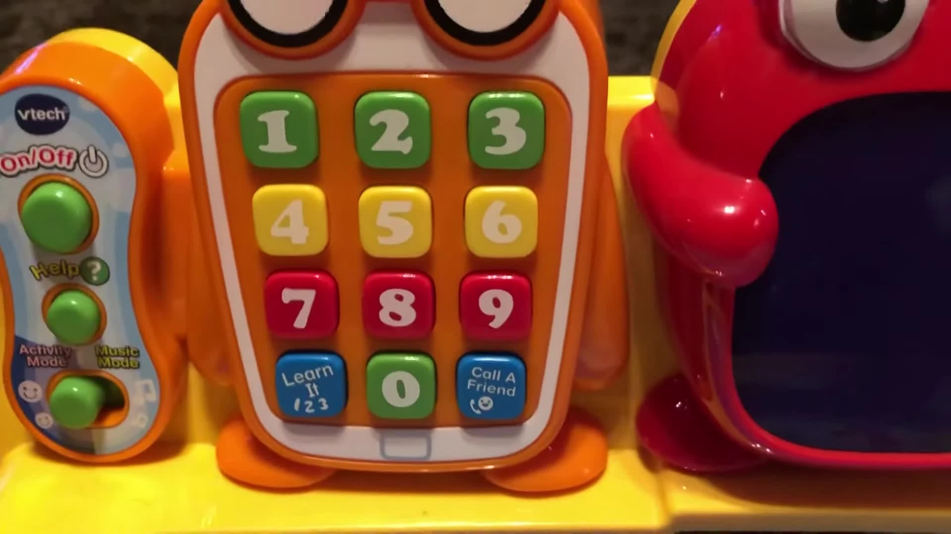 Close-up of the orange phone on the activity desk.