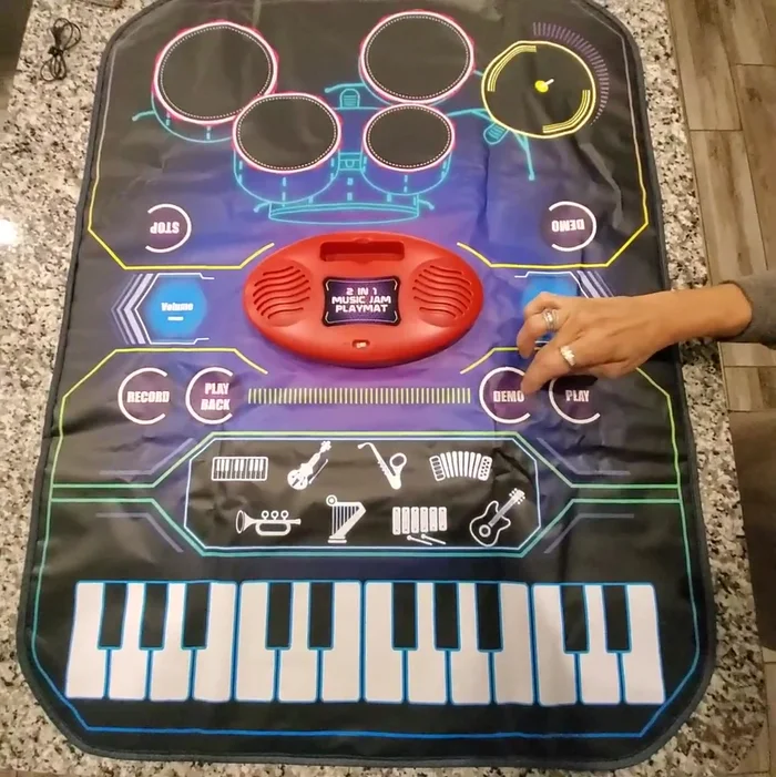 Volume Control: Adjust volume using the volume buttons on either side of the playmat (note: external device volume may need adjustment as well).