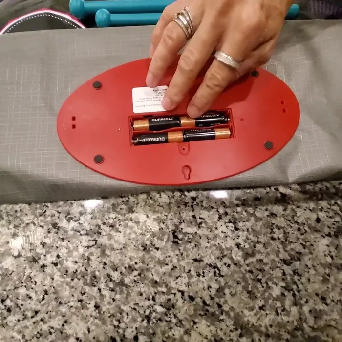 Set up the playmat: Place the playmat on a flat surface or hang it vertically on a wall or door using the provided feet.