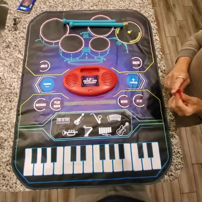 Set up the playmat: Place the playmat on a flat surface or hang it vertically on a wall or door using the provided feet.