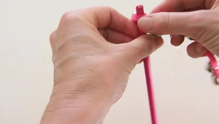 Push the jingle bells along the dowel, arranging them as desired, and twist the pipe cleaner around the stick to secure them.