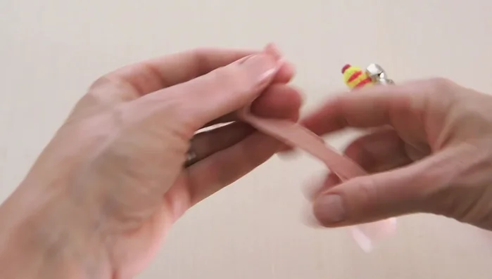 Cut a 4-5 inch piece of ribbon and loop it through the pipe cleaner at the top, tying it to secure.