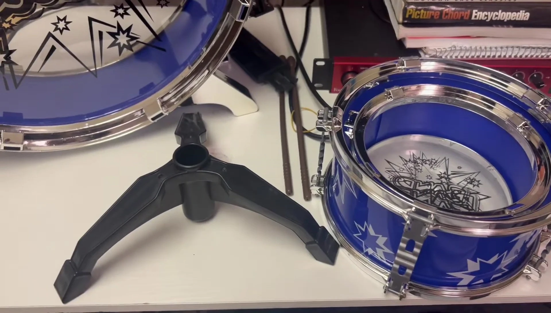 The disassembled snare drum stand parts.