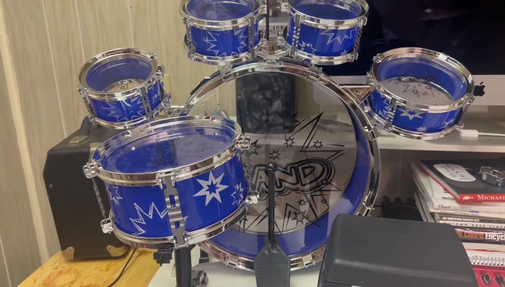 A child playing the assembled drum set.