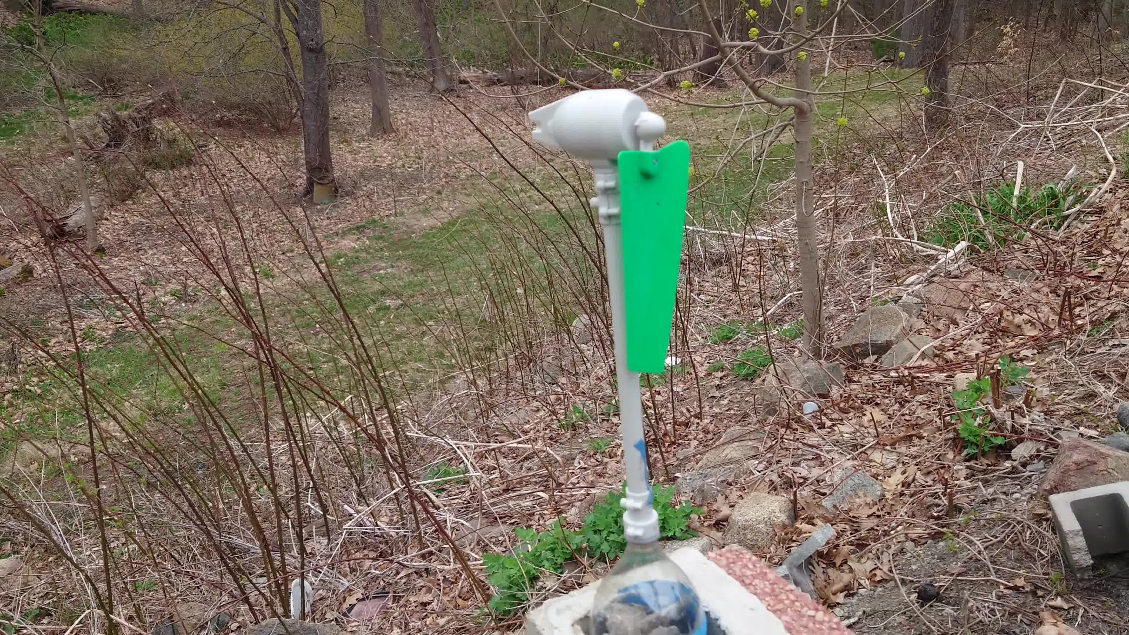 The wind turbine mounted on a pole outdoors.