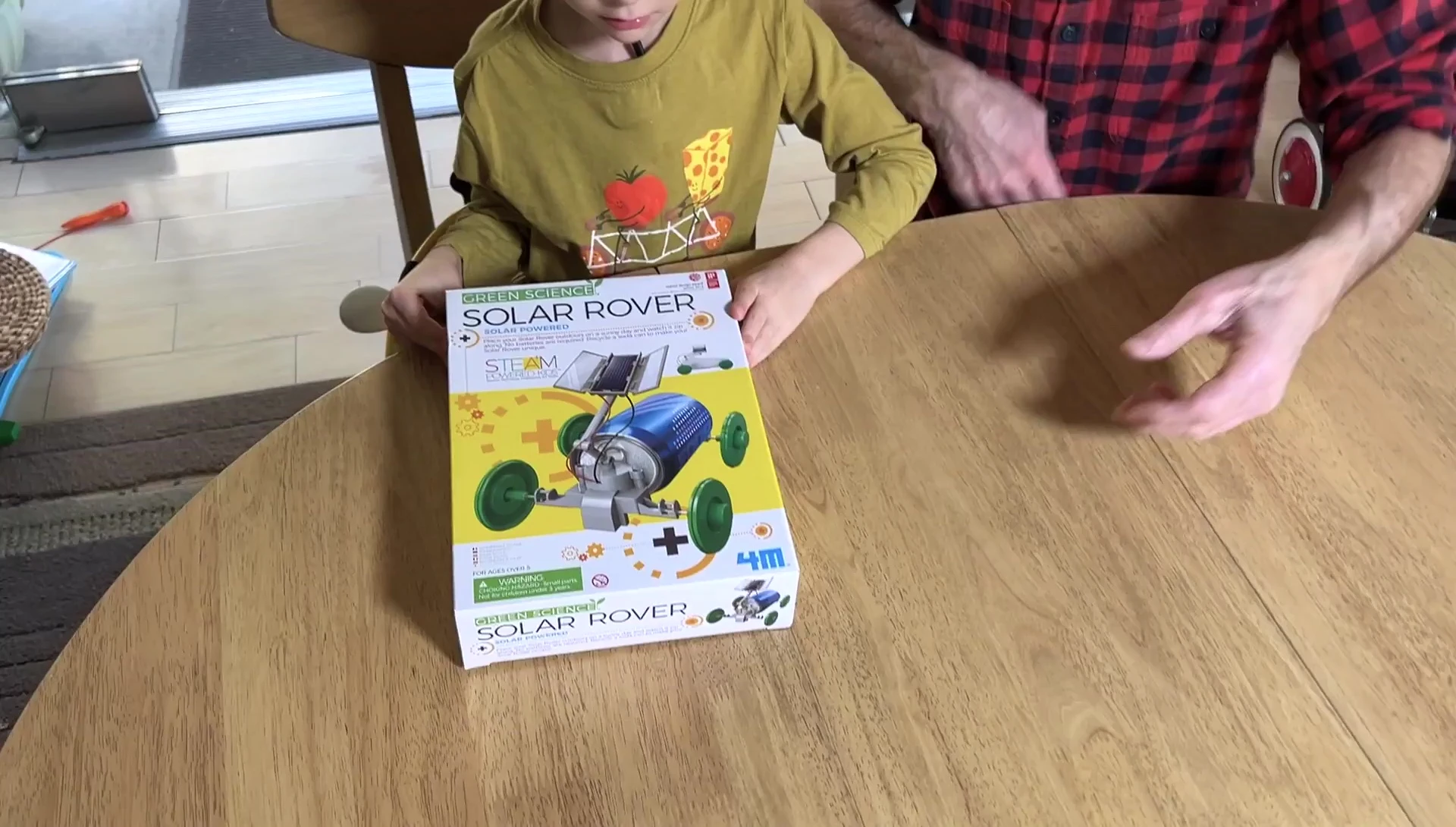 Close-up shot of the Solar Rover kit box being opened.
