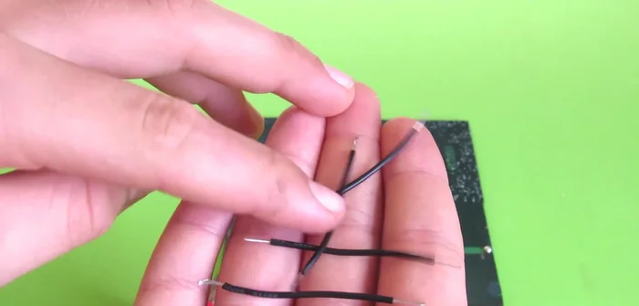 Solder wires to the solar panels: connect positive contacts together, then negative contacts together. Create two pairs of wires to connect to the motors.