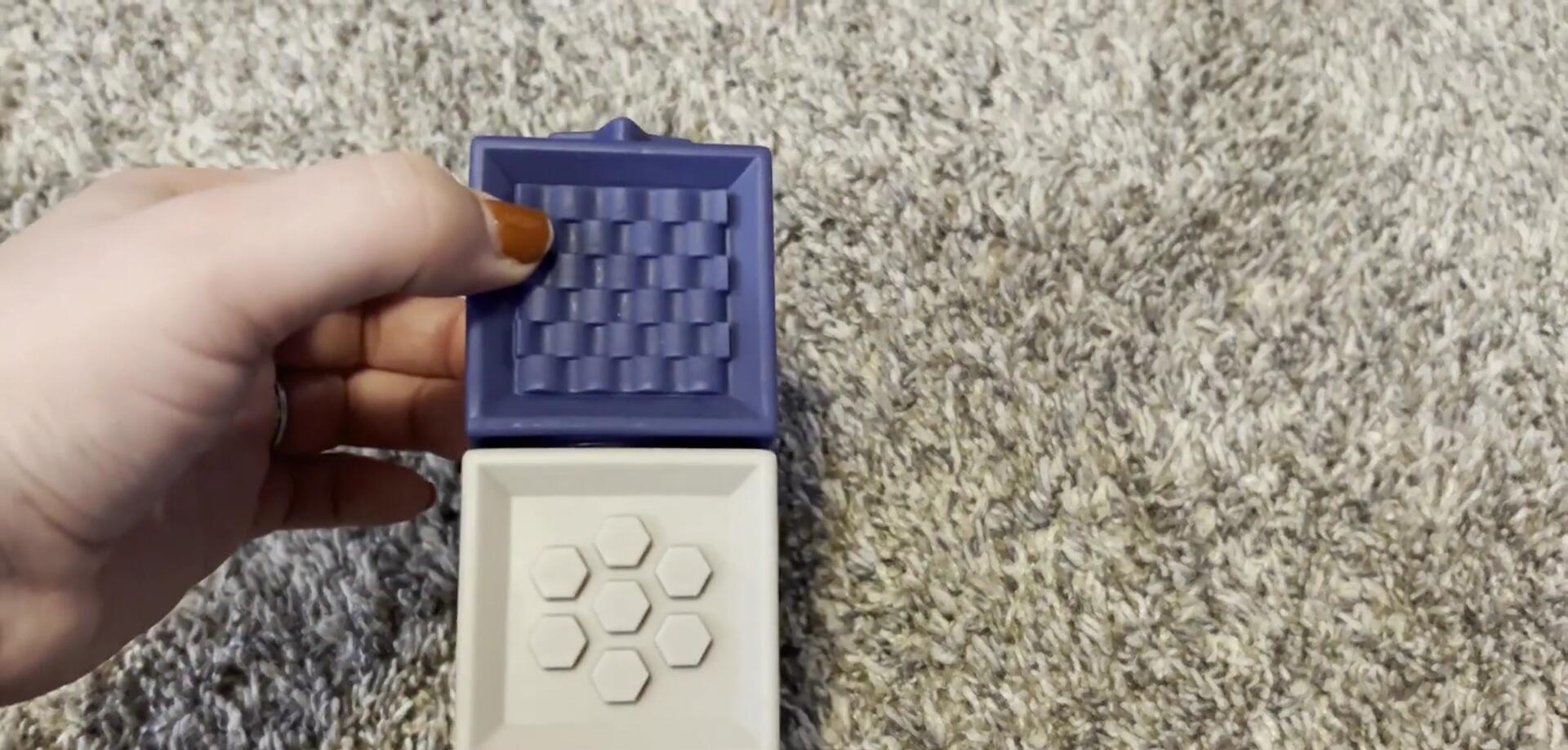 Baby Riley interacting with the cubes, showcasing their chew-toy function.