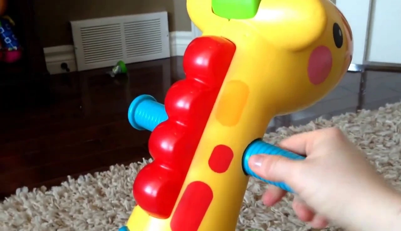 Close-up showcasing the handles of the giraffe toy.