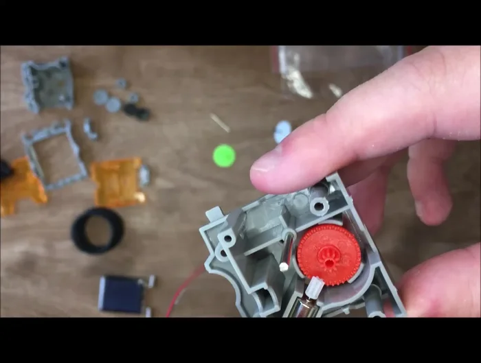 Assemble the base of the robot, including the wheels, motor, and gear assembly. Ensure wires are neatly tucked away.