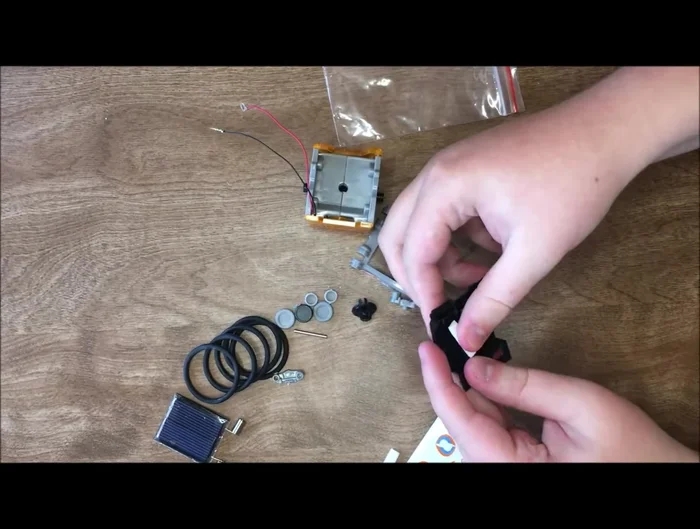 Assemble the neck and attach the head to the base, connecting the wires (red to positive, black to negative).