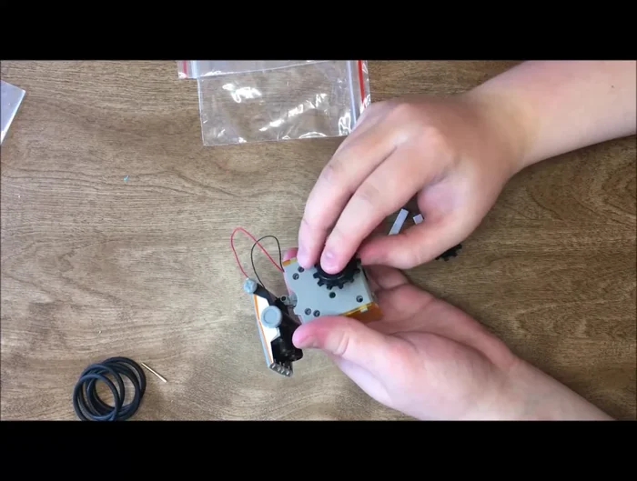 Attach the wheels to the robot's base. Test the robot in sunlight to ensure functionality; if it doesn't move, check the gray piece is fully inserted.