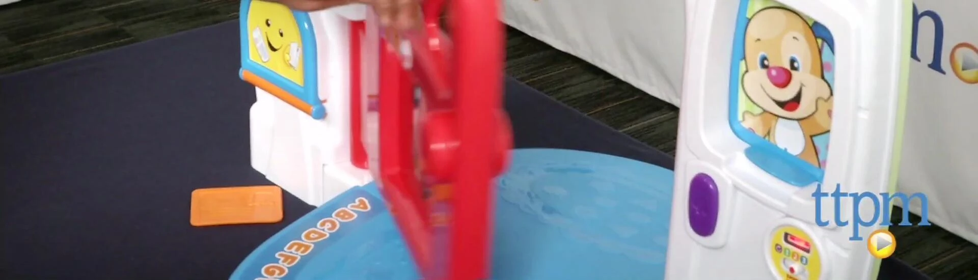 A child pretending to open the door on the toy.