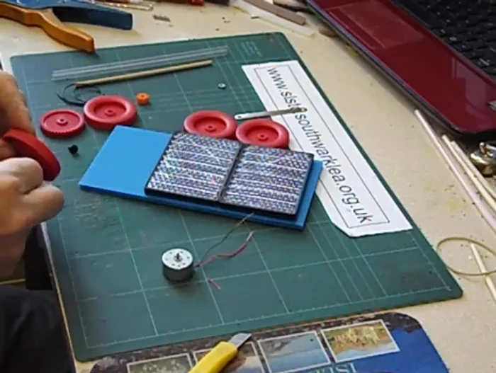 Fix the driven gear to the straw using glue.