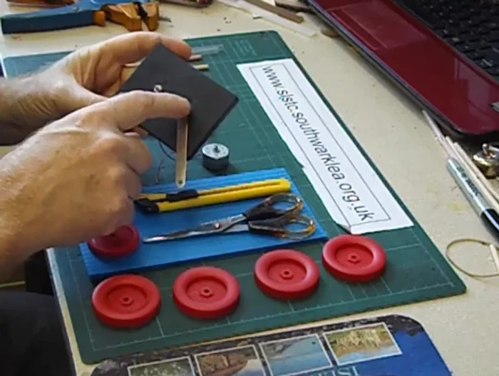 Enlarge holes (if needed) using a craft knife.