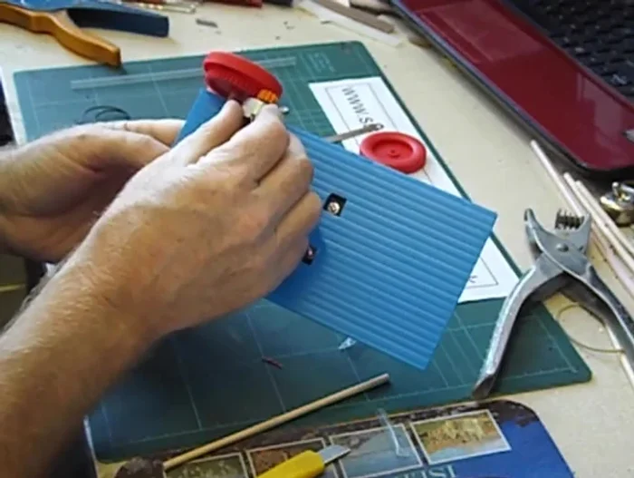 Connect the solar cells to the motor using nuts and wires.