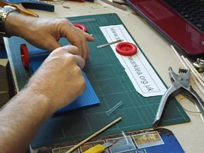 Connect the solar cells to the motor using nuts and wires.