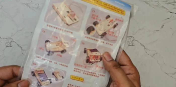 Identify and separate the Lego pieces. Check the booklet for guidance.