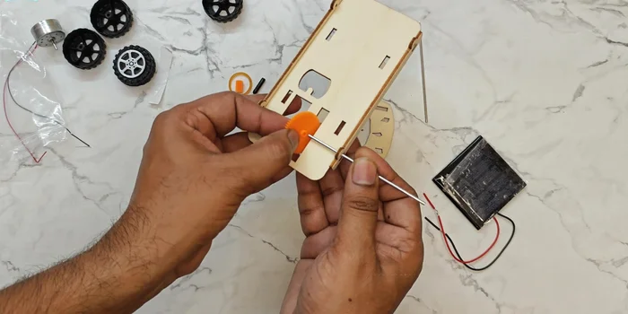 Attach the tires: Carefully place the tires onto their respective axles.