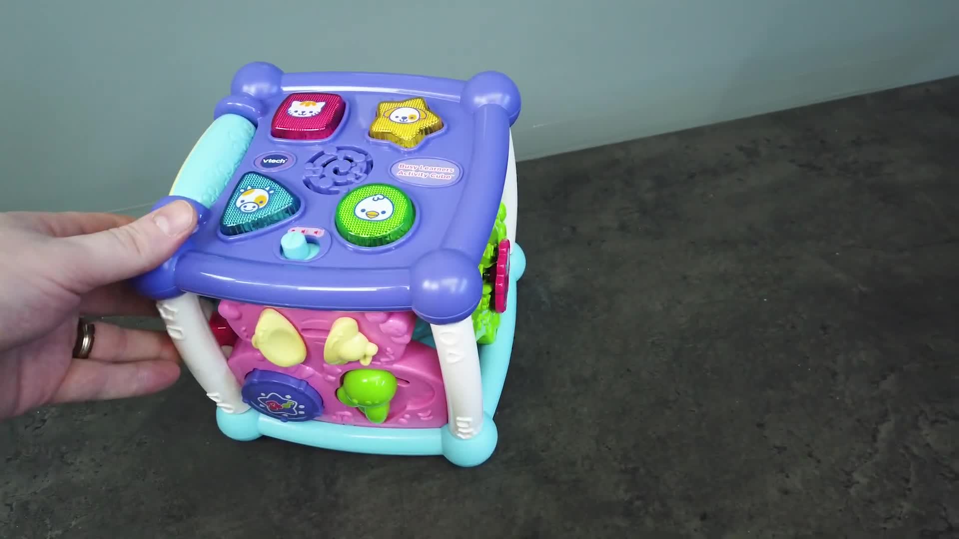 The child playing with the activity cube