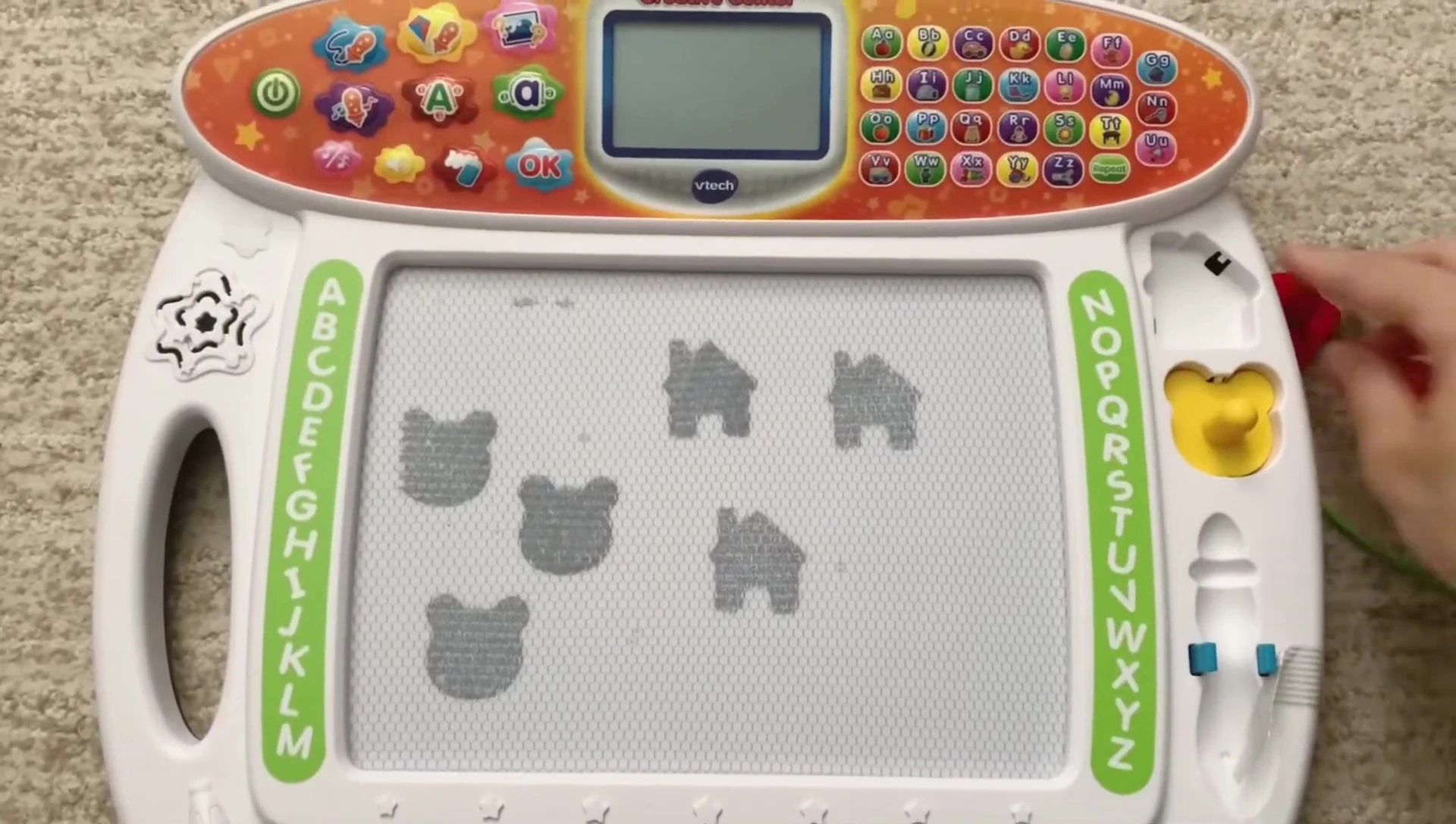 The reviewer holding the VTech Write & Learn Creative Center.