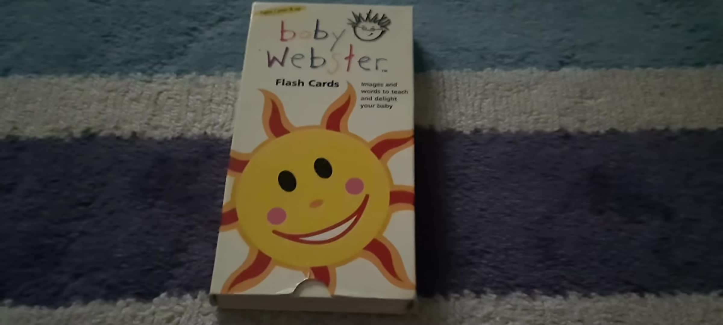 The narrator holding the Baby Webster Flash Cards box