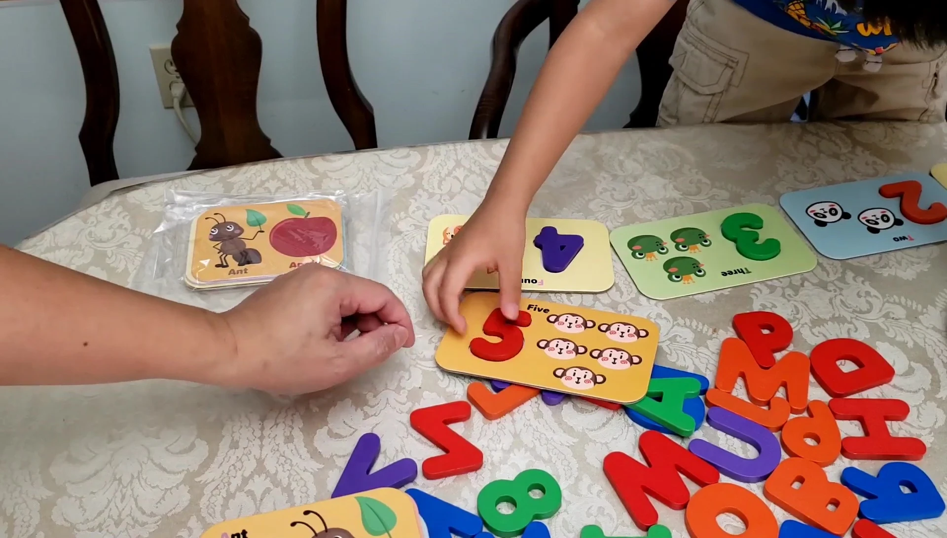 Child counting monkeys using the number cards