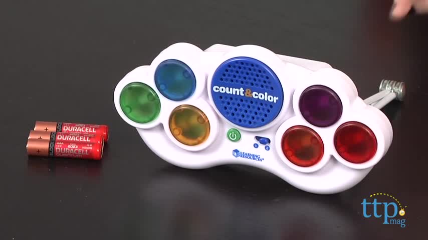 Child's hands interacting with the large buttons on the game