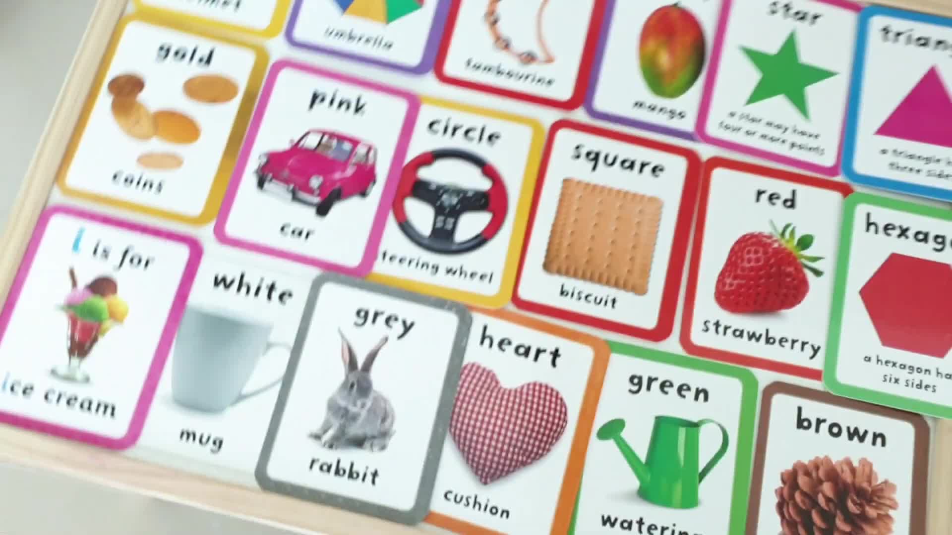 Kiara looking at color and shape flashcards