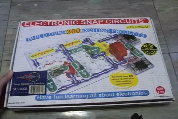 Unpack the kit: It includes instruction books (physical and online), components, and a breadboard.