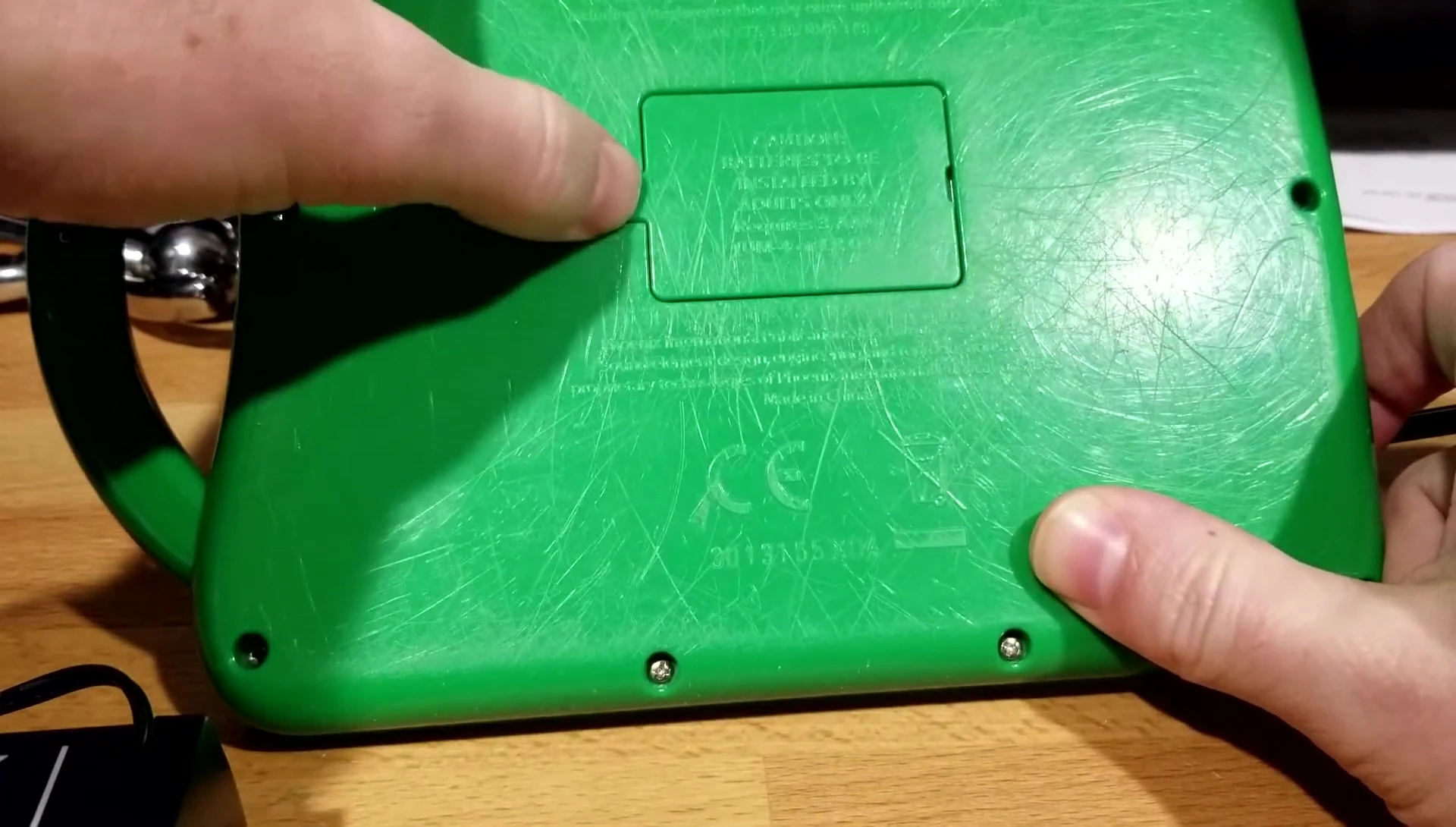 The battery compartment, emphasizing the difficult access.