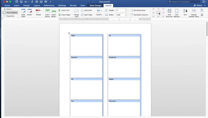 Go to 'Layout' and center align the text within the table cells.