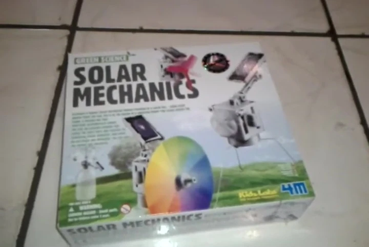 The reviewer holds up a partially opened kit showing some of its parts.