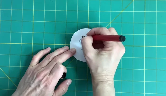 Draw a bird in the middle of the card, ensuring it's not upside down when the card is spun. Color it in.