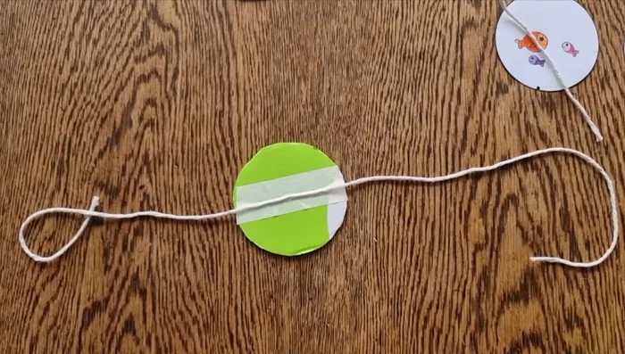 Glue the opposite side of the picture (upside down, aligning the black dots) to the other side of the disc.