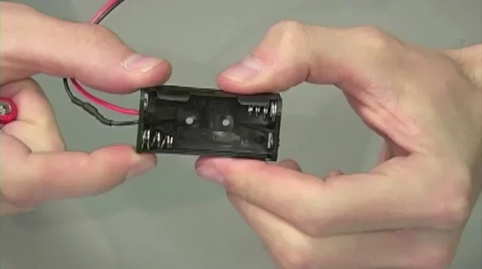 Assemble Battery Module: Insert AAA batteries into battery pack, insert into B7 with A7 pieces and inner wheel parts.