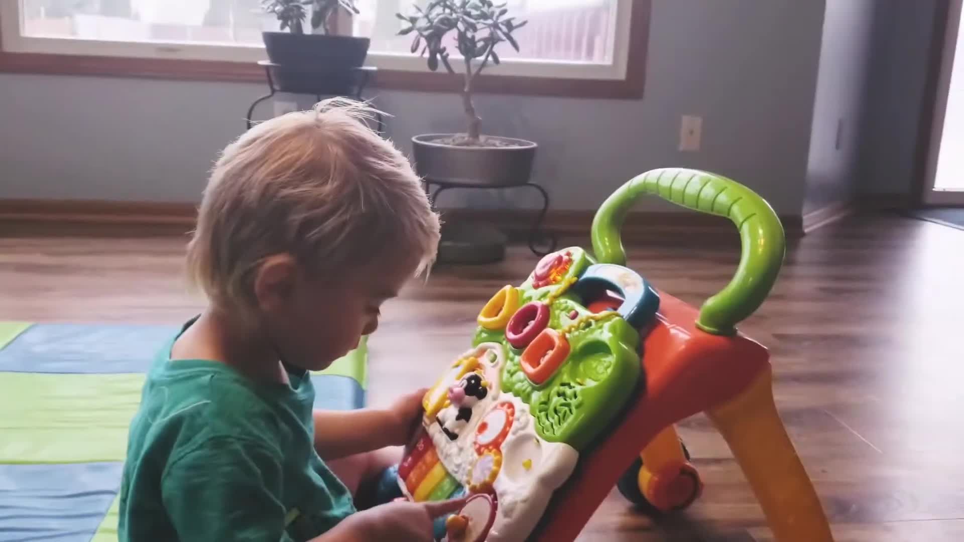 Toddler playing with the VTech walker.