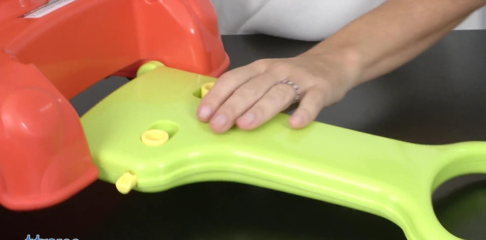 Toddler using the car as a sit-on bouncer