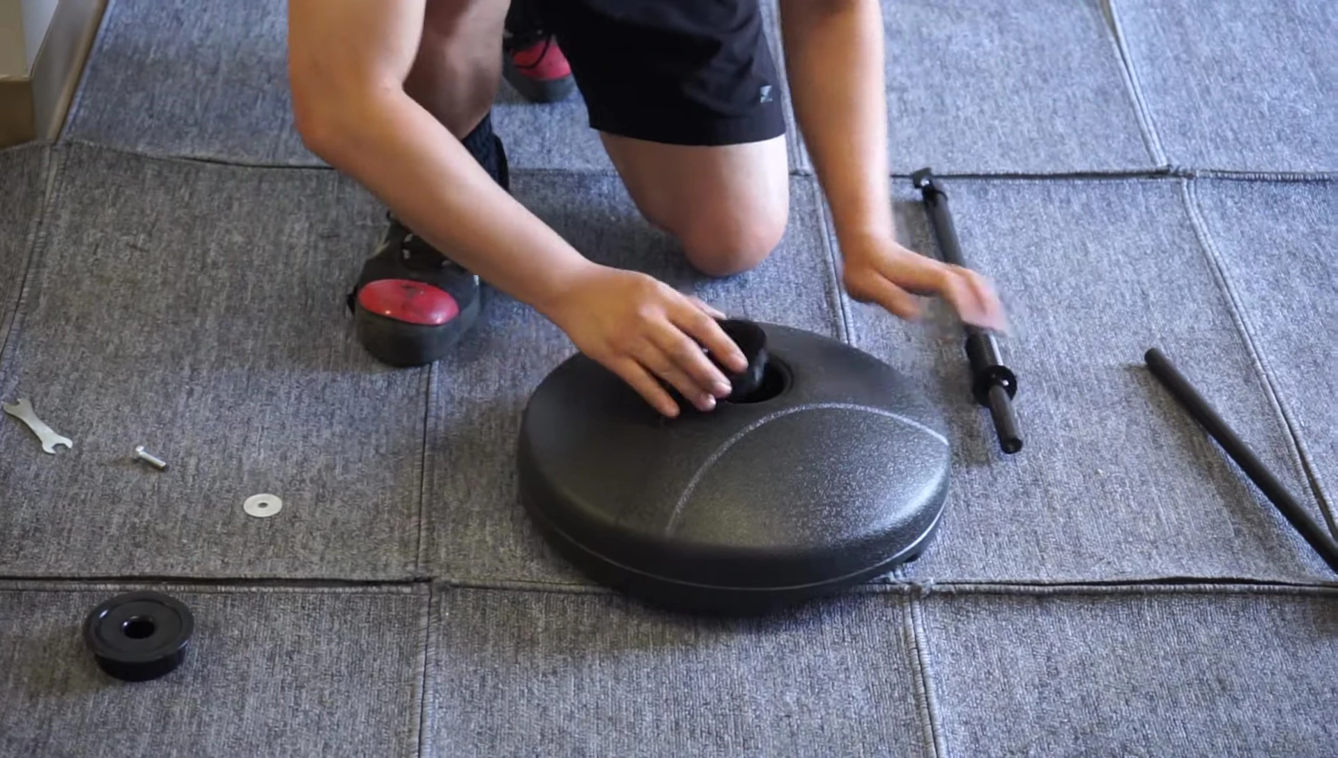 Inserting the long pipe into the large ring.