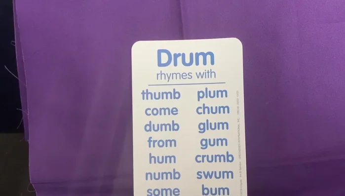 Provide examples of words that rhyme with 'drum' (thumb, come, swam, bum).