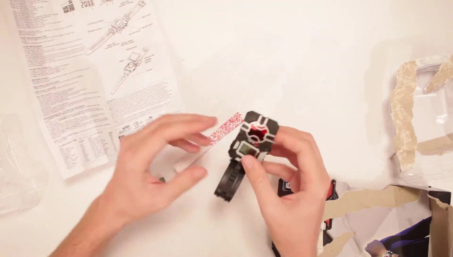 The reviewer demonstrates how the watch face flips up and down.