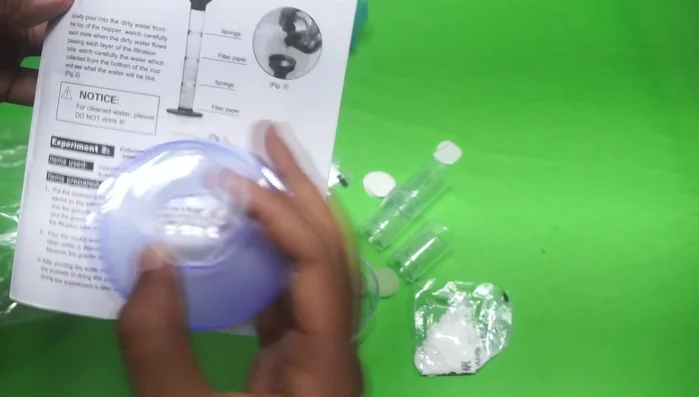 Place the filter tube inside the plastic hopper. Make sure it's securely positioned.
