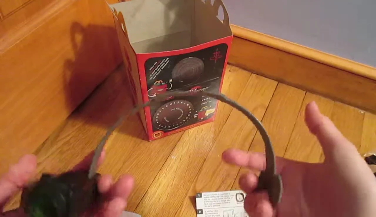 The reviewer is showing how small the toy is in comparison to their head.