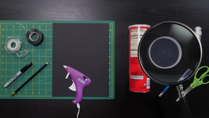 Cut the rim off an extra Pringles lid and cut a hole for the flashlight, securing it with tape.