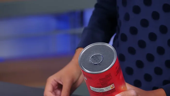 Cut the rim off an extra Pringles lid and cut a hole for the flashlight, securing it with tape.